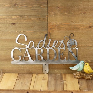 Personalized garden sign with first name and ladybug, in raw steel.