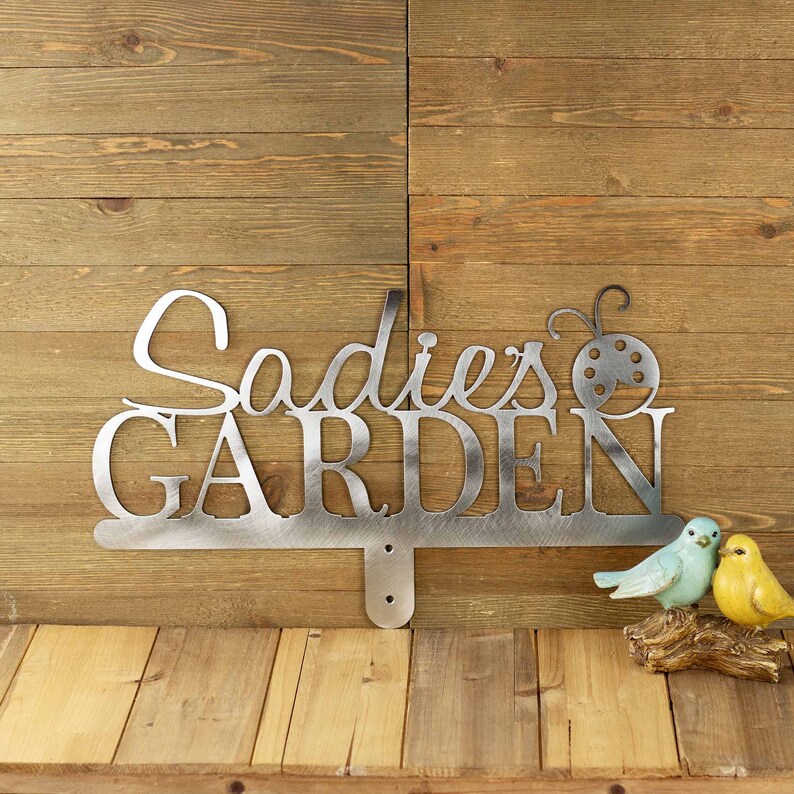 Personalized garden sign with first name and ladybug, in raw steel.