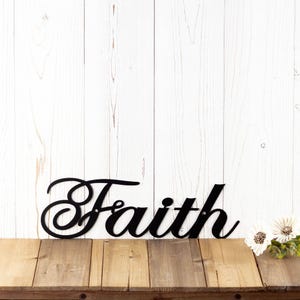 Faith metal sign with cursive lettering, in matte black powder coat.