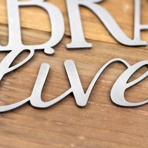 Close up of raw steel on our Labradors Live Here metal wall art.