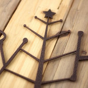 Close up of copper vein powder coat on our Happy Holidays metal wall art.