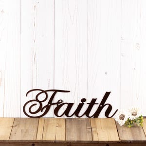 Faith metal sign with cursive lettering, in copper vein powder coat.