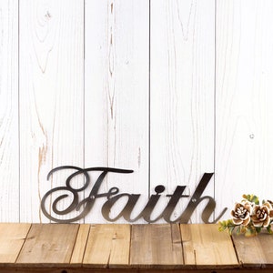 Faith metal plaque with cursive lettering, in raw steel.