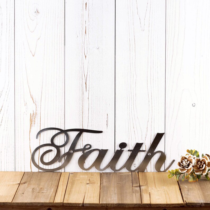 Faith metal plaque with cursive lettering, in raw steel.