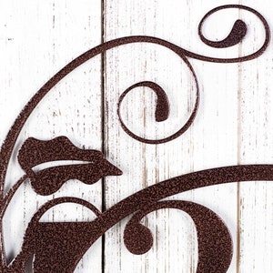 Close up of vines on our metal house number sign in copper vein powder coat.