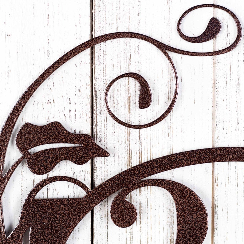 Close up of vines on our metal house number sign in copper vein powder coat.