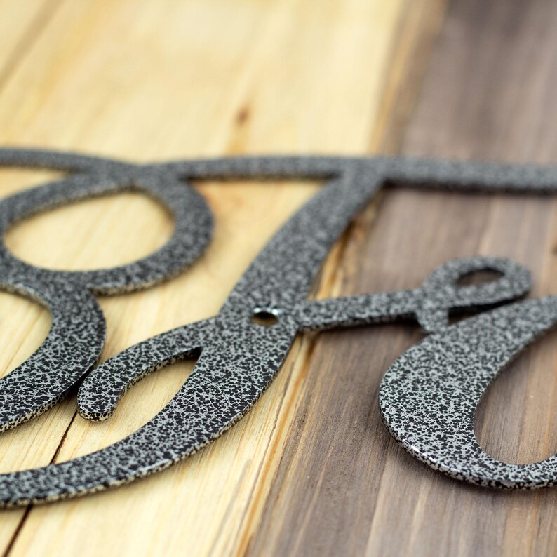 Close up of silver vein powder coat on our Faith metal wall art.