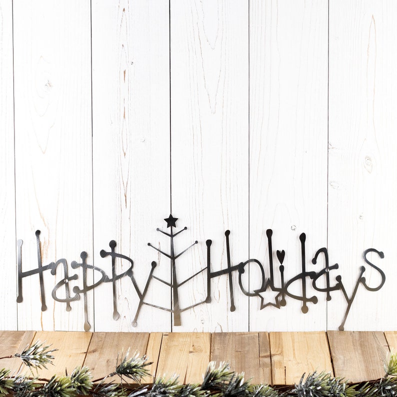 Happy Holidays metal wall art with Christmas tree, in raw steel.