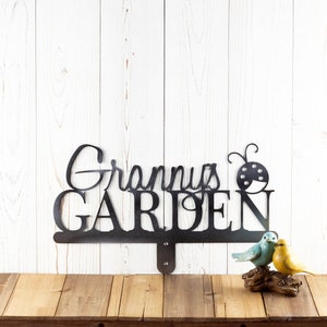 Garden name metal yard sign, with a ladybug silhouette, in raw steel.