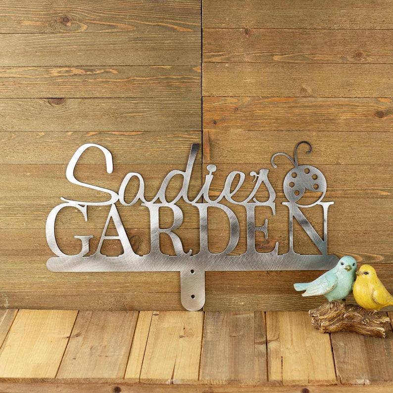 Custom garden name sign with first name and ladybug, in raw steel.