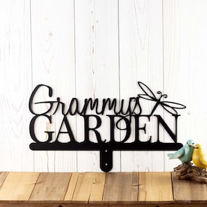 Garden name metal yard sign, with a dragonfly silhouette, in matte black powder coat.
