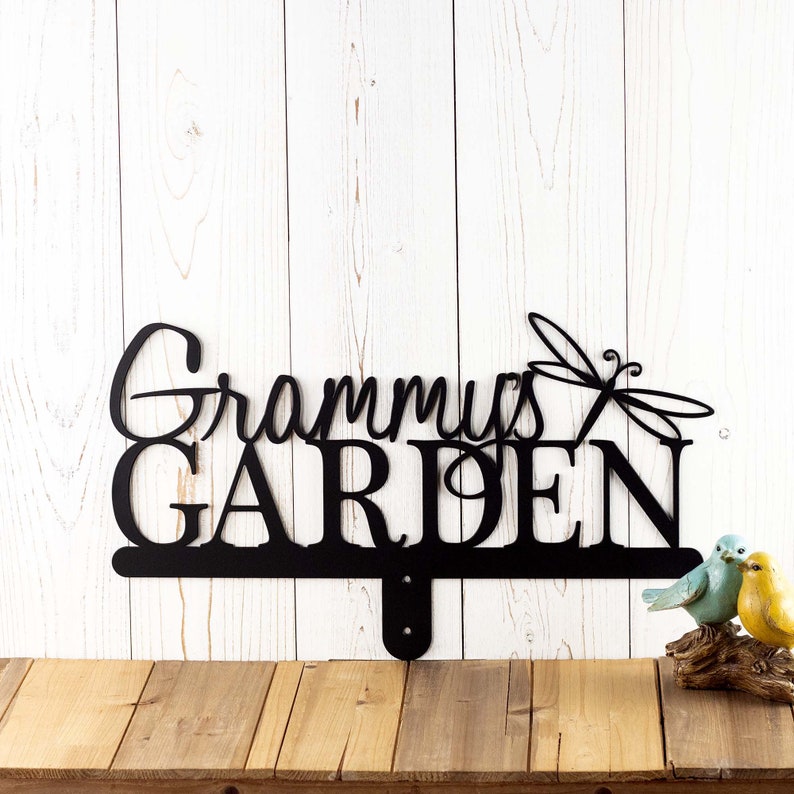 Metal garden sign with first name and dragonfly, in matte black powder coat.