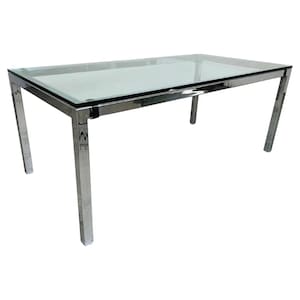 May include: A rectangular dining table with a clear glass top and a chrome-finished metal frame. The table is approximately 60 inches long and 30 inches wide, with four angled legs. The design is modern and minimalist.