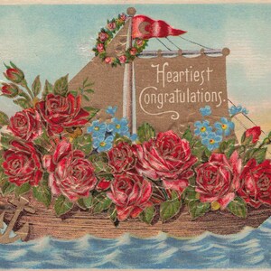 Meilleurs voeux : carte postale ancienne « Toutes nos félicitations » - Motif bateau floral en relief - Début des années 1900
