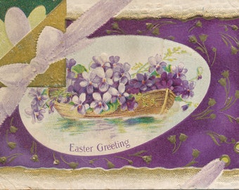 Postal vintage de 1917 "Saludos de Pascua" con canoa floral