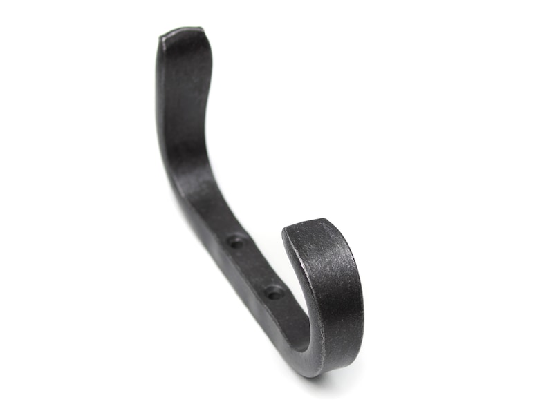 May include: A black metal hook with a curved design and three holes for mounting.