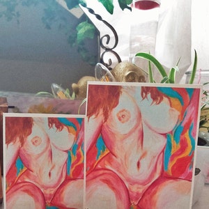 May include: Two prints of a nude female figure with long red hair. The figure is painted in a realistic style with a soft, warm color palette. The background is a vibrant mix of red, orange, yellow, and blue.