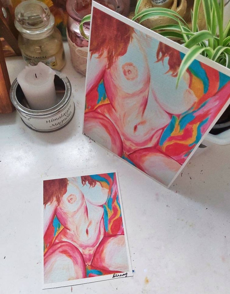 May include: Two prints of a nude female figure in a colorful abstract background. The figure is painted in a realistic style with soft pink and white tones. The background is a vibrant mix of red, orange, yellow, blue, and green.