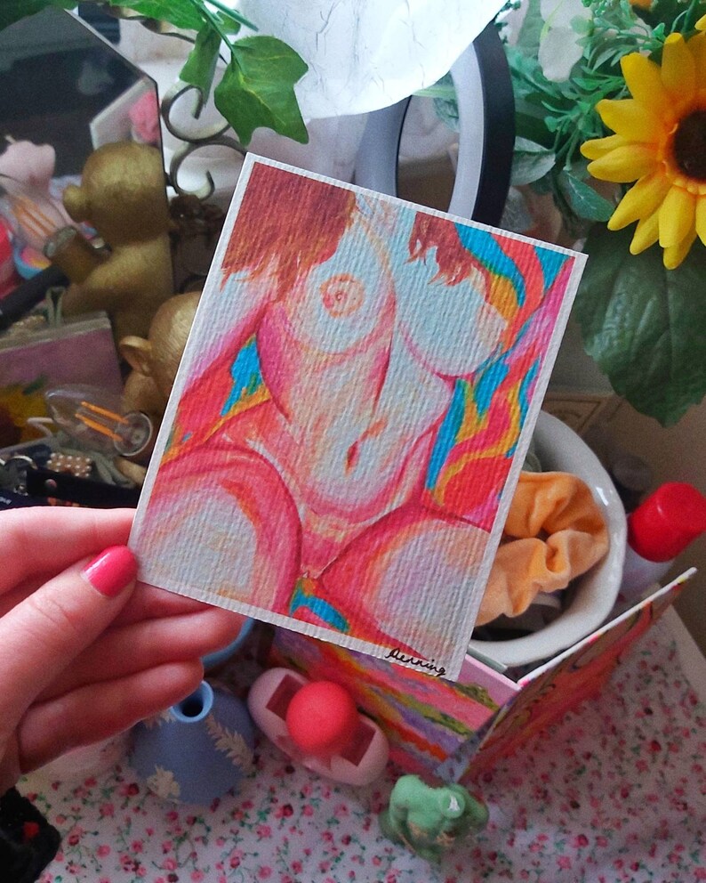 May include: A colorful drawing of a person's torso with a rainbow background. The drawing is on a white card with the word "burning" written in pink at the bottom.