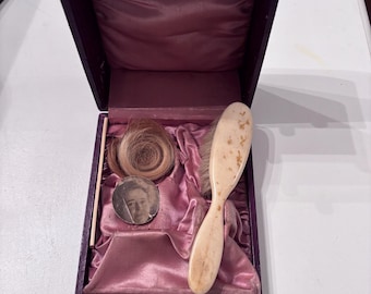 Antique leather baby box with contents