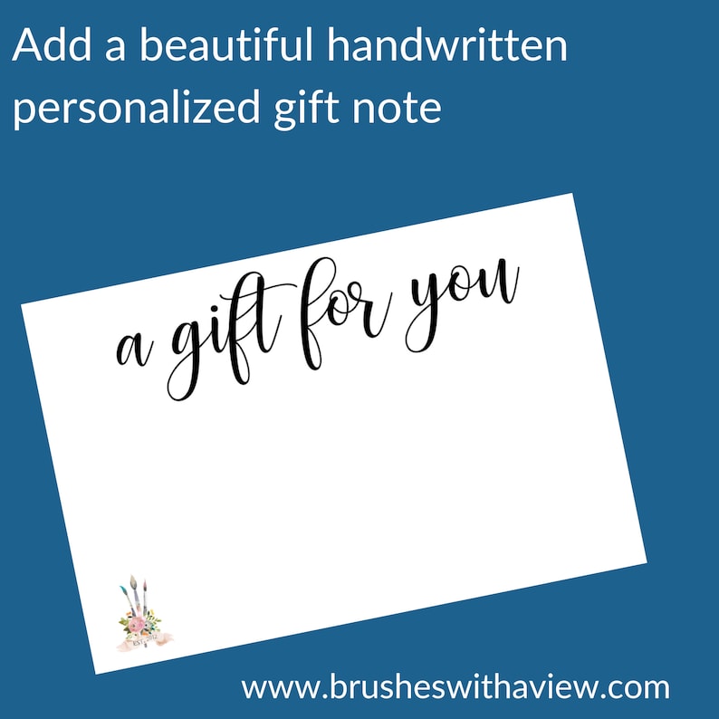 May include: A white card with the text "a gift for you" written in black cursive script. The card has a small watercolor illustration of paintbrushes and flowers in the bottom left corner. The text "www.brusheswithaview.com" is printed in black at the bottom of the card.