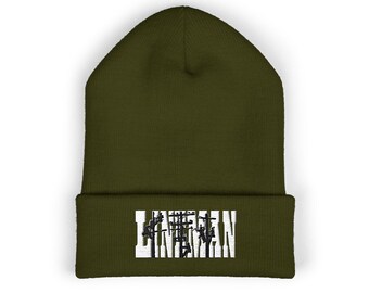 May include: Olive green beanie with the word "LINEMAN" embroidered in white and black. The beanie is a classic, cuffed style, perfect for cold weather. The text is centered on the cuff.