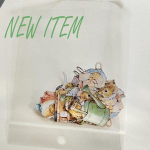 May include: A vintage-style illustration of a group of mice carrying a variety of items, including a watering can, a basket, and a book. The illustration is printed on a white background and is packaged in a clear plastic bag.