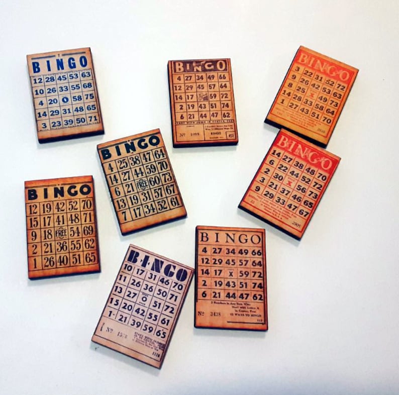 May include: Nine vintage bingo cards with a brown background and black text. The cards have a traditional bingo grid with numbers 1-75. The cards are arranged in a semi-circle on a white surface.