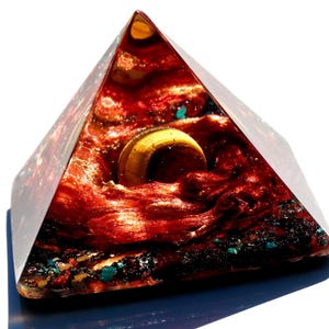 May include: A red, gold, and blue resin pyramid with a gold orb inside. The pyramid is on a blue base.