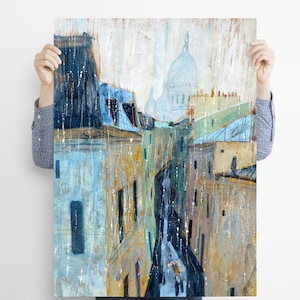 May include: A painting of a Parisian street scene with a view of the Sacr&eacute;-C&oelig;ur Basilica in the distance. The buildings are painted in shades of blue, yellow, and white, and the street is lined with trees. The painting is done in a loose, impressionistic style.