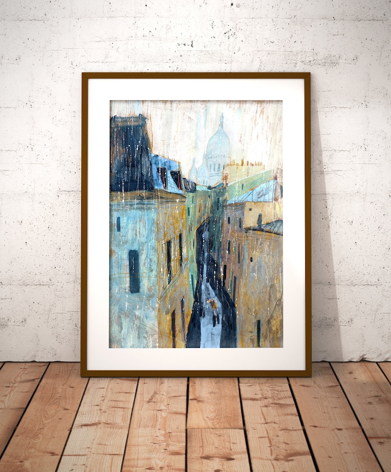 May include: A painting of a narrow street in Paris, France. The street is lined with buildings and the Sacr&eacute;-C&oelig;ur Basilica is visible in the distance. The painting is done in a watercolor style and features a light blue, yellow, and white color palette.