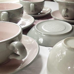 Harkerware Oven Proof Shell pink dinnerware pieces. Shell pink with dove gray undersides. Mid Century Modern plates, cups and saucers sold in set