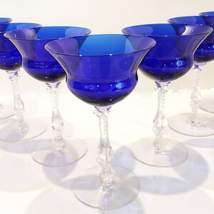 Set of 7 Antique Cobalt Royal Blue 3126 Cambridge Glass Champagne / Tall Sherbet Stemware.  Beautiful, clear cobalt blue art deco style angular flare top on a bulbous, bulging bowl with graceful foliated clear glass tall stems.