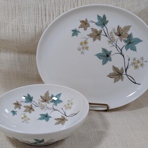 Mid‑century Syracuse China Woodbine pieces including an oval platter and serving bowl with the aqua and brown floral motif on a bright white glaze.
