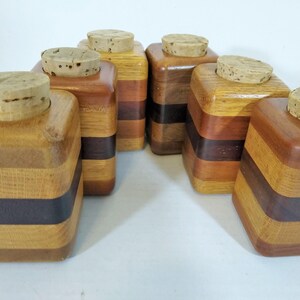 Mid Century Turned Stacked Layered Wood Spice Containers with Cork Stoppers. Set of 6 wooden spice jars  made of Layers of various varieties of dark and light colored wood stacked together, turned, and finished to warm rich layers of natural wood.