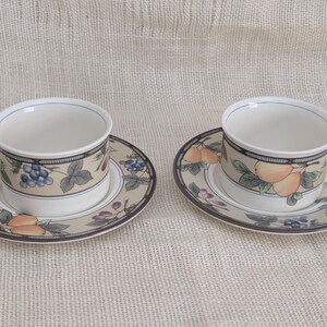 Mikasa Garden Harvest CAC29 2 cup and saucer sets with fruit and leaf border on cream glaze.