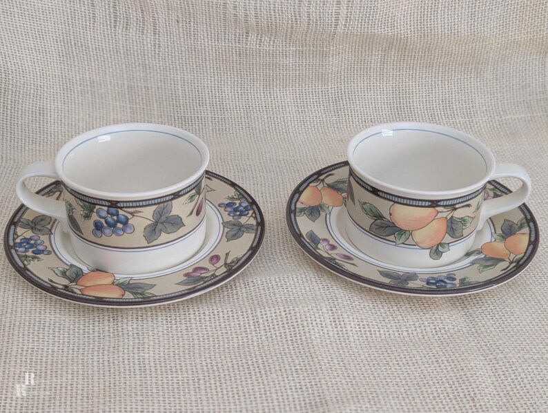 Mikasa Garden Harvest CAC29 2 cup and saucer sets with fruit and leaf border on cream glaze.