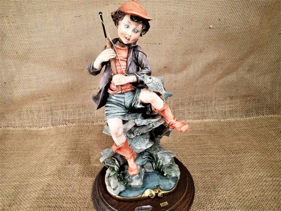 boy fishing figurine