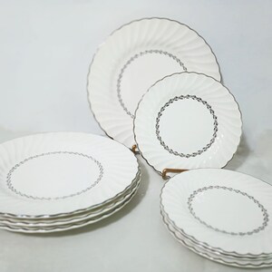 Mid Century Homer Laughlin Arcadia Dinnerware. Silver Platinum wreath of leaves around inner circle, Platinum trim on scalloped rimmed white china Dinner Plates and Salad Plates