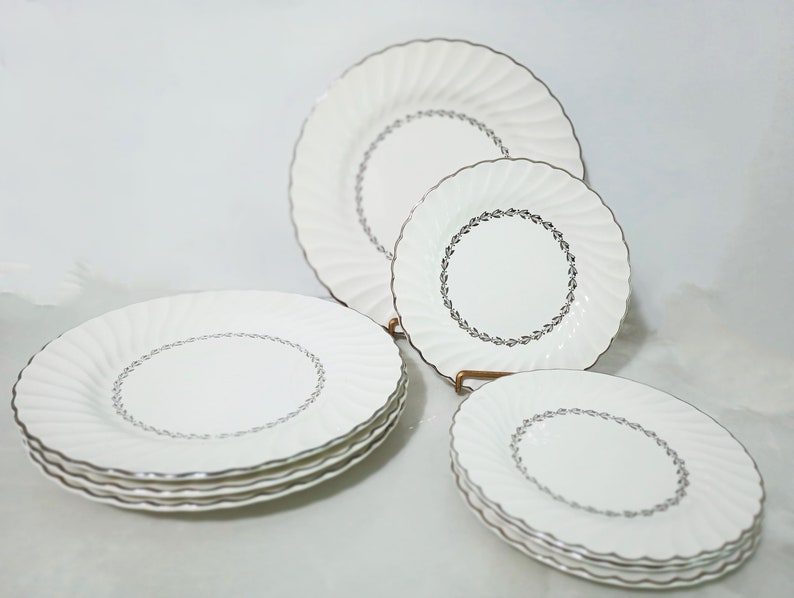 Mid Century Homer Laughlin Arcadia Dinnerware. Silver Platinum wreath of leaves around inner circle, Platinum trim on scalloped rimmed white china Dinner Plates and Salad Plates