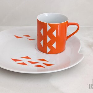 Jonas Roberts Japan snack set with white yin yang snack plate with orange diamonds and orange cup with white diamond pattern