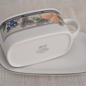 Mikasa Garden Harvest CAC29 stoneware Gravy Boad and Underplate with fruit and leaf border on cream glaze. Bottom view with backstamp