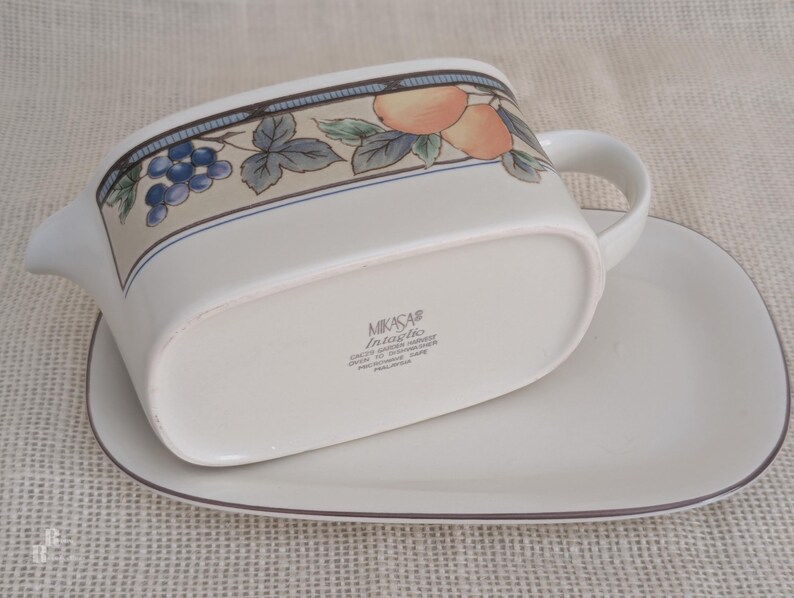 Mikasa Garden Harvest CAC29 stoneware Gravy Boad and Underplate with fruit and leaf border on cream glaze. Bottom view with backstamp