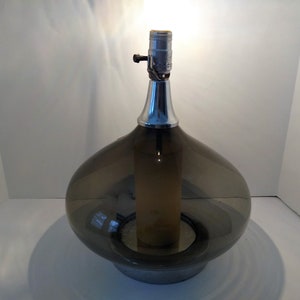 Mid Century Modern Minimalist Blenko Art Glass Table Lamp. Hand blown smoke glass garlic shape body, chrome finish neck and base. Fiberglass light diffuser inside glass body for mood light.