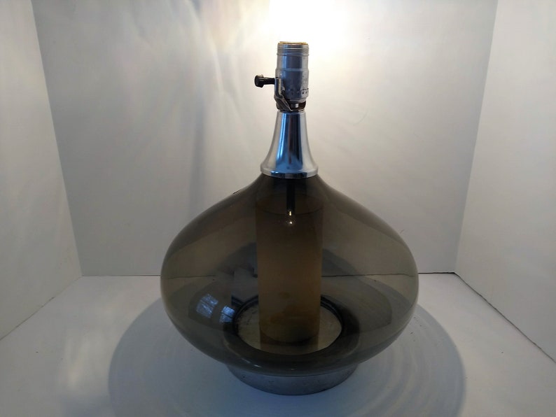 Mid Century Modern Minimalist Blenko Art Glass Table Lamp. Hand blown smoke glass garlic shape body, chrome finish neck and base. Fiberglass light diffuser inside glass body for mood light.