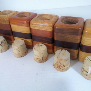 Mid Century Turned Stacked Layered Wood Spice Containers with Cork Stoppers. Set of 6 wooden spice jars  ade of Layers of various varieties of dark and light colored wood stacked together, turned, and finished to warm rich layers of natural wood.