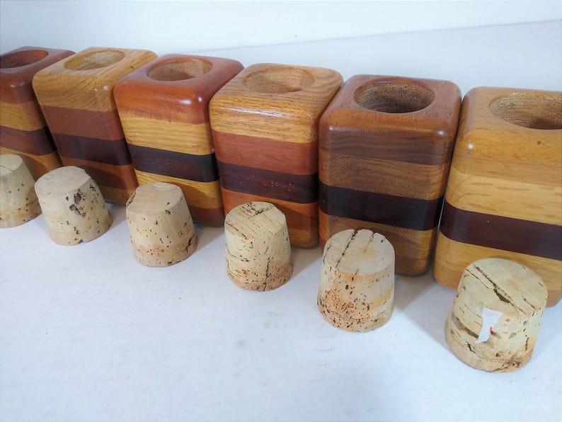 Mid Century Turned Stacked Layered Wood Spice Containers with Cork Stoppers. Set of 6 wooden spice jars  ade of Layers of various varieties of dark and light colored wood stacked together, turned, and finished to warm rich layers of natural wood.