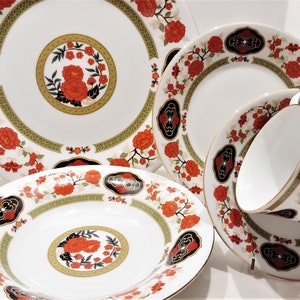 Lilily Cakara Dinnerware set, service for 8 Dinner plartes, salad plates, Soup Bowl, cup and saucer. Also Large oval platter, vegetable bowl and Covered Sugar (1)