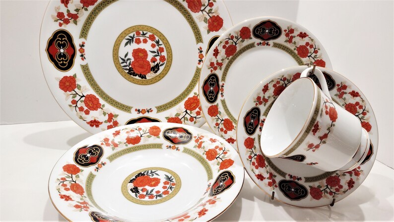 Lilily Cakara Dinnerware set, service for 8 Dinner plartes, salad plates, Soup Bowl, cup and saucer. Also Large oval platter, vegetable bowl and Covered Sugar (1)