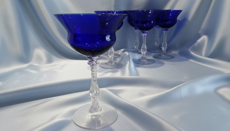 Set of 7 Antique Cobalt Royal Blue 3126 Cambridge Glass Champagne / Tall Sherbet Stemware.  Beautiful, clear cobalt blue art deco style angular flare top on a bulbous, bulging bowl with graceful foliated clear glass tall stems.